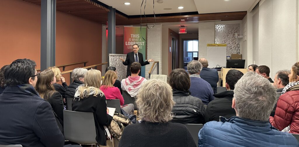 Photo of Timmon Wallis speaking to a full room at the briefing at FCNL in DC